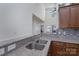 Granite counters and backsplash in kitchen, stainless steel sink and hardware, and warm wood cabinets at 623 Hicklin Dr, Rock Hill, SC 29732