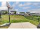 Large backyard with basketball court, grassy lawn, and dark metal and wood fence at 7027 Waterwheel St, Concord, NC 28025