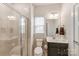 Bright bathroom with a glass shower, dark vanity and large mirror at 7027 Waterwheel St, Concord, NC 28025