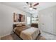 Neutral bedroom featuring a queen bed, chest of drawers, and floating shelves at 7027 Waterwheel St, Concord, NC 28025