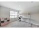 Bright bedroom featuring a modern loft bed with a built-in desk and organized storage cube at 7027 Waterwheel St, Concord, NC 28025