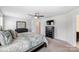 Well-lit bedroom with a ceiling fan, a television, and dark wood furniture set at 7027 Waterwheel St, Concord, NC 28025