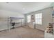 Bright bedroom featuring a loft bed with built-in desk, storage cube, and neutral-colored walls at 7027 Waterwheel St, Concord, NC 28025