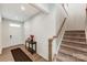 Foyer with a decorative table, rug, staircase, and a white front door at 7027 Waterwheel St, Concord, NC 28025