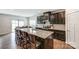 Open kitchen with island seating, stainless steel appliances, and views to the dining area at 7027 Waterwheel St, Concord, NC 28025