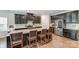 Modern kitchen featuring dark cabinetry, stainless steel appliances, and granite countertops with seating at the island at 7027 Waterwheel St, Concord, NC 28025