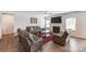 Spacious living room with a fireplace, large television, and comfortable leather seating at 7027 Waterwheel St, Concord, NC 28025