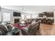 Open concept living room with dark wood floors, cozy furniture, fireplace, and kitchen view at 7027 Waterwheel St, Concord, NC 28025