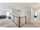 Bright loft area with railing and a cozy sitting area off to the side at 7027 Waterwheel St, Concord, NC 28025