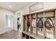 Inviting mudroom with cubbies, bench, wood floors and decorative 'Home' wall art at 7027 Waterwheel St, Concord, NC 28025