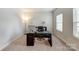 Bright home office with a large desk, comfortable chair, and natural light from the window at 7027 Waterwheel St, Concord, NC 28025