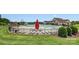 Community pool area featuring lounge chairs, umbrellas, and a slide for Gathering fun at 7027 Waterwheel St, Concord, NC 28025