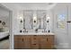 Bathroom features a double vanity with framed mirrors, modern fixtures, and bright natural light at 7214 Benita Dr, Charlotte, NC 28212