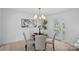 Bright dining room featuring a modern chandelier and glass table with seating for four, offering a welcoming atmosphere at 7214 Benita Dr, Charlotte, NC 28212