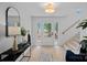 Inviting foyer with light hardwood floors and a staircase to the upper level at 7214 Benita Dr, Charlotte, NC 28212