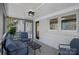 Comfortable screened porch with gray painted deck, modern light fixture, and white brick wall at 7214 Benita Dr, Charlotte, NC 28212