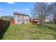 Large grassy backyard featuring a partially covered deck, offering ample room for activities and relaxation at 7619 Woodknoll Dr, Charlotte, NC 28217