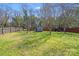 Fenced backyard with a storage shed at 7619 Woodknoll Dr, Charlotte, NC 28217