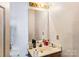 Simple bathroom featuring a vanity, mirror, and basic fixtures at 7619 Woodknoll Dr, Charlotte, NC 28217