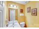 Bright bathroom with a vanity, toilet, and decorative wall art at 7619 Woodknoll Dr, Charlotte, NC 28217