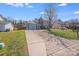 Long driveway leading to a two-story home with an attached garage at 7619 Woodknoll Dr, Charlotte, NC 28217