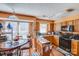 Well-lit kitchen featuring essential appliances, wooden cabinets and granite countertop island at 7619 Woodknoll Dr, Charlotte, NC 28217