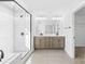 Modern bathroom featuring a dual-sink vanity and sleek glass-enclosed shower with white tile at 8005 Rolling Wheels Rd, Charlotte, NC 28215