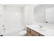 A bright bathroom featuring tub and shower, light wood cabinetry, and a wide mirror above the sink at 8005 Rolling Wheels Rd, Charlotte, NC 28215