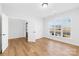 Bright and airy bedroom featuring hardwood floors and large windows overlooking the front yard at 8005 Rolling Wheels Rd, Charlotte, NC 28215