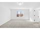 Bright bedroom with neutral carpet, large window, and adjacent bathroom for a seamless transition at 8005 Rolling Wheels Rd, Charlotte, NC 28215