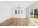 Open dining room area with modern chandelier and hardwood floors at 8005 Rolling Wheels Rd, Charlotte, NC 28215