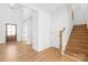 Inviting entryway with hardwood floors and staircase leading to the upper level at 8005 Rolling Wheels Rd, Charlotte, NC 28215