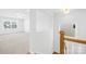 Bright hallway showcasing hardwood stairs leading to a large carpeted room with natural light at 8005 Rolling Wheels Rd, Charlotte, NC 28215