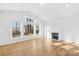 Bright living room with a fireplace and large windows offering ample natural light at 8005 Rolling Wheels Rd, Charlotte, NC 28215