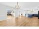 Bright and airy living room featuring an open layout, hardwood floors, and modern lighting at 8005 Rolling Wheels Rd, Charlotte, NC 28215