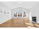 Sun-filled living room features a fireplace and large windows overlooking the yard at 8005 Rolling Wheels Rd, Charlotte, NC 28215