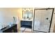 Well-lit bathroom featuring a modern vanity, double sinks, and a glass-enclosed shower at 816 Osteen Rd, York, SC 29745