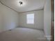 A cozy bedroom with a window offering natural light and plush carpeting for added comfort at 816 Osteen Rd, York, SC 29745