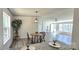 Bright dining area features wood-look floors and a modern light fixture with adjacent living space at 816 Osteen Rd, York, SC 29745