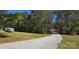 Gravel driveway through property lined by trees leads to a home and includes an RV at 816 Osteen Rd, York, SC 29745