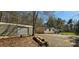 A single story home with neutral siding, mature trees, an outbuilding and gravel landscaping at 816 Osteen Rd, York, SC 29745