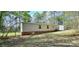 Exterior view of a single story home with a landscaped yard and access to a storage shed at 816 Osteen Rd, York, SC 29745