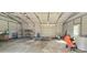 Interior view of the outbuilding including work bench and other household items with roll up door at 816 Osteen Rd, York, SC 29745