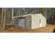 View of the backyard shed featuring a sliding door and a Personal door, surrounded by trees at 816 Osteen Rd, York, SC 29745