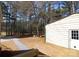 View of the backyard shed featuring a door with windows, surrounded by trees and open space at 816 Osteen Rd, York, SC 29745