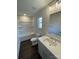 Bathroom with a bathtub/shower, commode, vanity, and window at 8704 Moody Rd, Charlotte, NC 28215