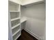 Walk in closet with built in shelves and wood floor at 8704 Moody Rd, Charlotte, NC 28215