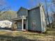 Charming home featuring a covered porch, vinyl siding, and a well-manicured lawn surrounded by mature trees at 8704 Moody Rd, Charlotte, NC 28215