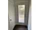 Bright hallway featuring a back door and white trim at 8704 Moody Rd, Charlotte, NC 28215