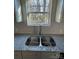 Elegant kitchen featuring granite countertops, stainless sink, gray cabinets, and a window view at 8704 Moody Rd, Charlotte, NC 28215